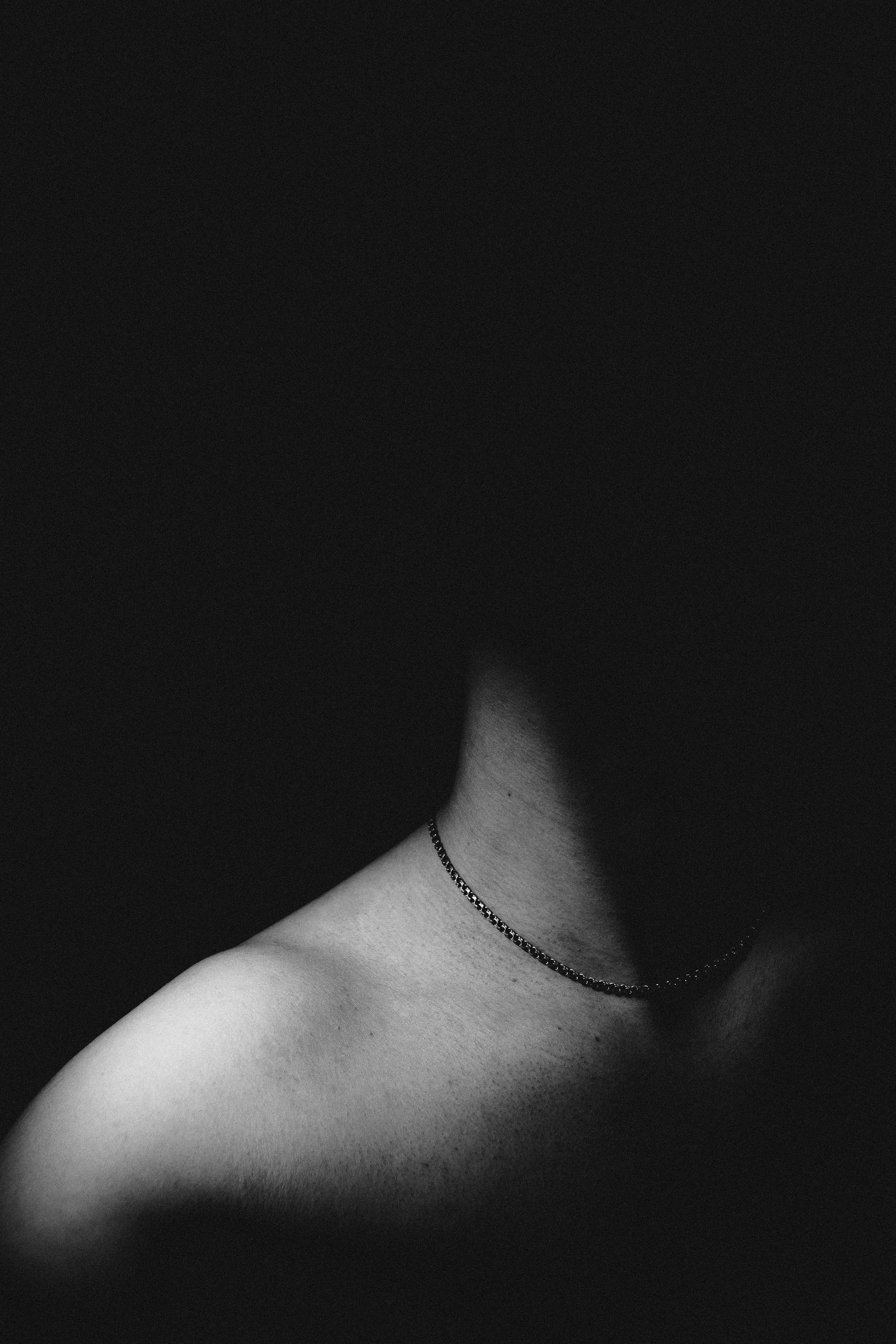person wearing silver chain necklace